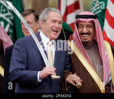 us-president-bush-left-shares-a-laugh-with-saudi-prince-salman-brother-of-saudi-king-abdullah-while-watching-a-traditional-sword-dance-at-the-al-murabba-palace-and-natural-history-muesum-in-al-janadriyah-saudi-arabia-tuesday-jan-15-2008-ap-photosusan-walsh-2pak3y4.jpg