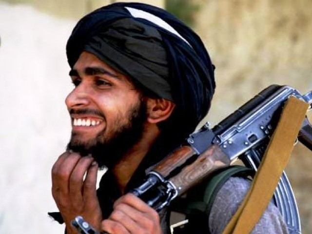 A-Taliban-militant-smiles-as-he-holds-his-weapon-outside-the-mosque-where-tribal-elders-and-Taliban-met-in-Daggar-Buners-main-town-AP-640x480.jpg