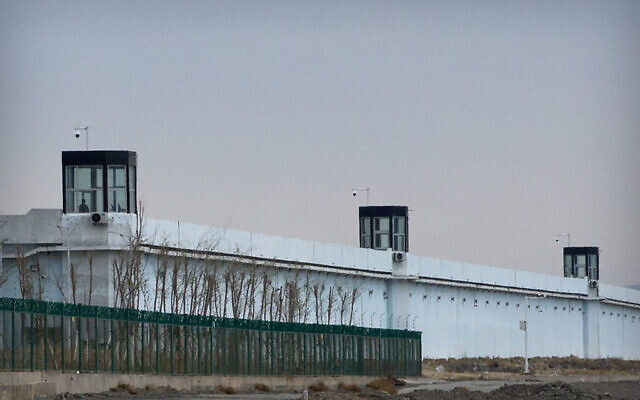 A person stands in a tower on the perimeter of the Number 3 Detention Center in Dabancheng in western China's Xinjiang Uyghur Autonomous Region on April 23, 2021. Human rights groups and Western nations led by the United States, Britain and Germany accused China of massive crimes against the Uyghur minority and demanded unimpeded access for U.N. experts  (AP Photo/Mark Schiefelbein)